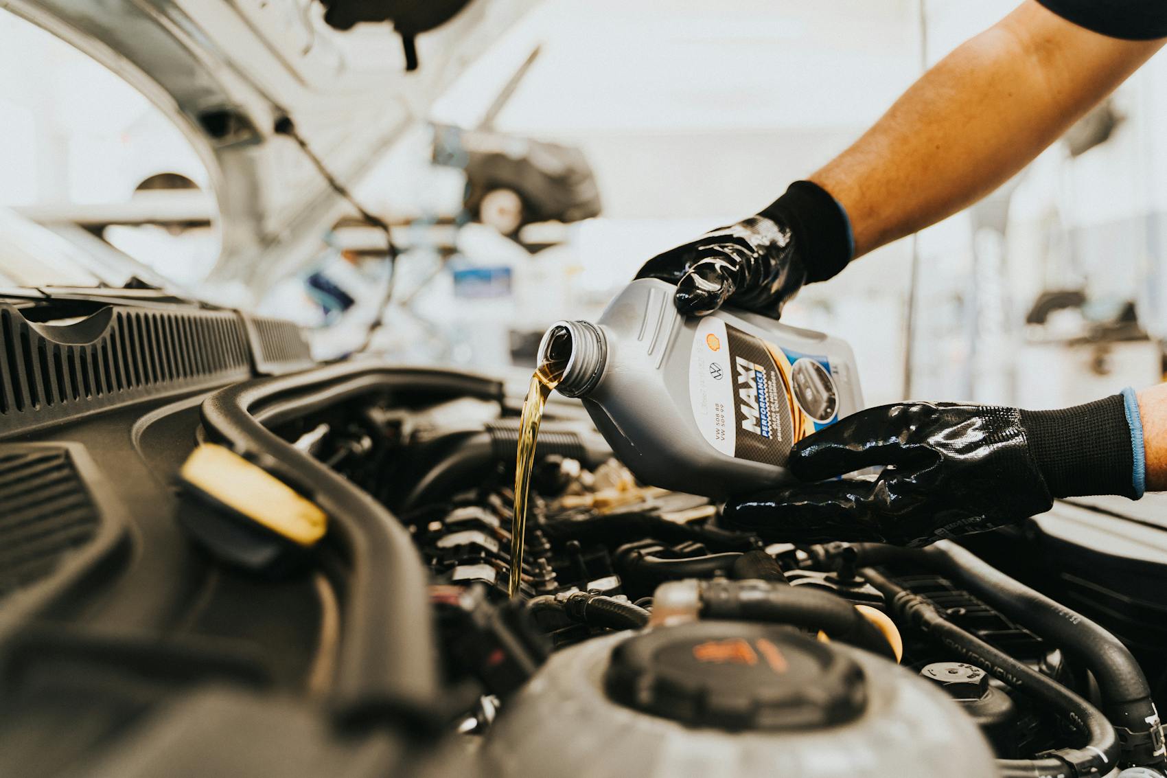 Fresh oil being poured into an engine at Ismael and Son